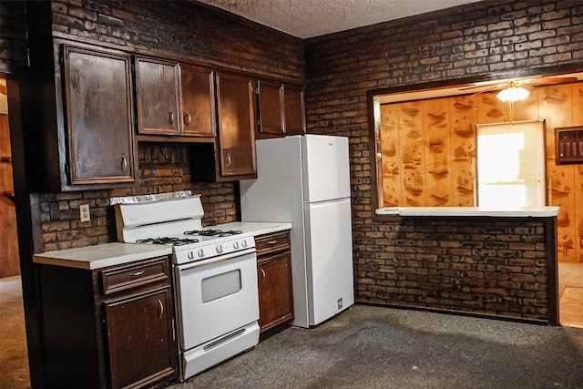 kitchen featuring white appliances, ceiling fan, dark brown cabinets, a textured ceiling, and brick wall