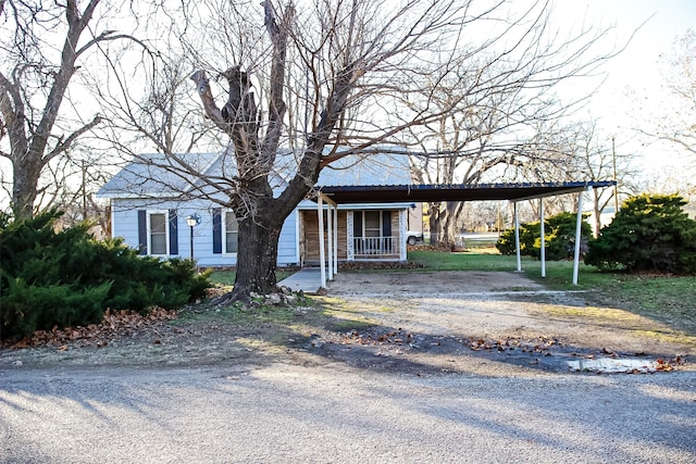 view of front of property with a carport and covered porch