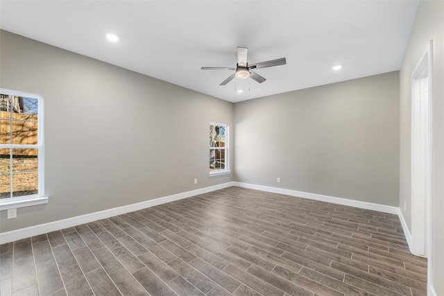 spare room with dark wood-type flooring and ceiling fan