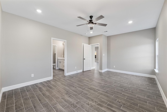 unfurnished bedroom with dark hardwood / wood-style floors, ceiling fan, and ensuite bathroom