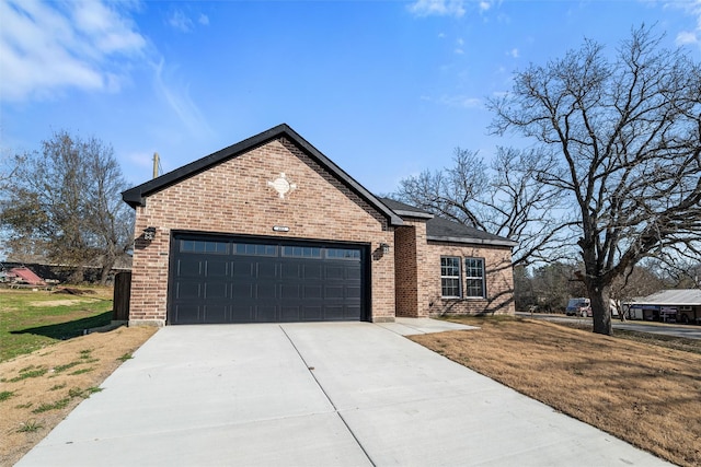 view of front of house with a garage and a front lawn