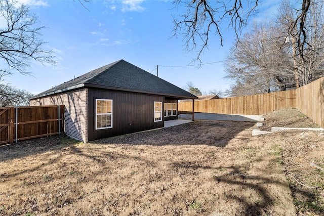 rear view of house featuring a yard and a patio area