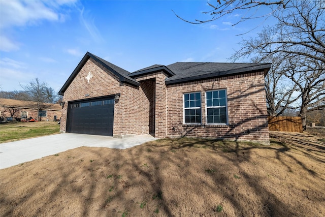 view of front of property with a garage and a front yard