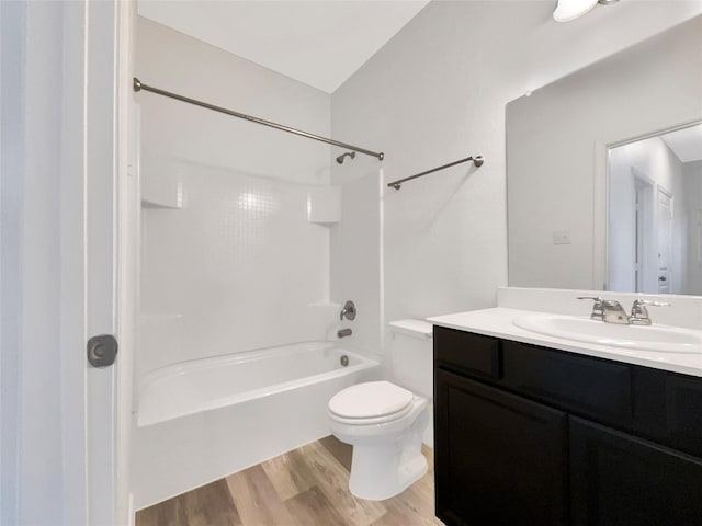 full bathroom featuring vanity, hardwood / wood-style floors, shower / bathtub combination, and toilet