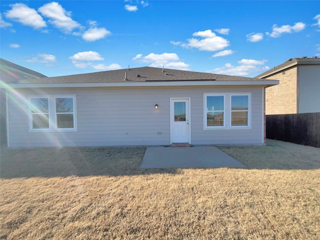 back of property with a patio area and a lawn