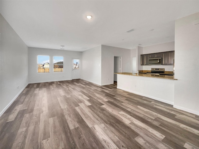 unfurnished living room with dark wood-type flooring and sink