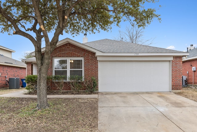 ranch-style home featuring central AC unit and a garage