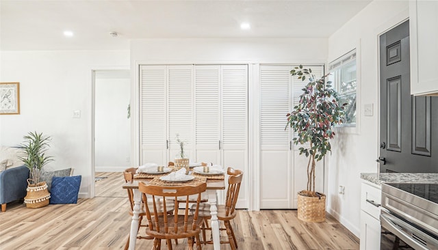 dining space with light hardwood / wood-style flooring