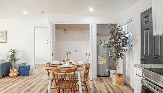 dining room with water heater and light hardwood / wood-style flooring