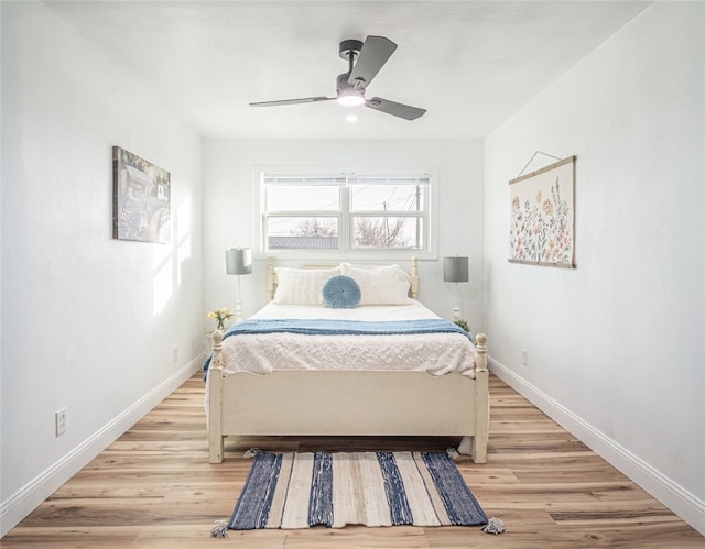 bedroom with ceiling fan and light hardwood / wood-style floors