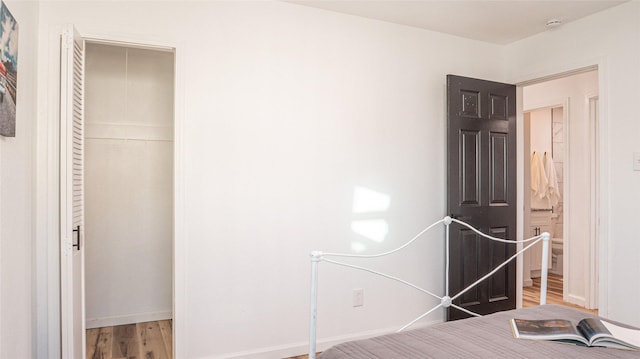 unfurnished bedroom featuring a closet and light hardwood / wood-style flooring