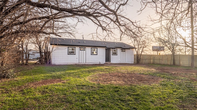 back of property featuring a yard