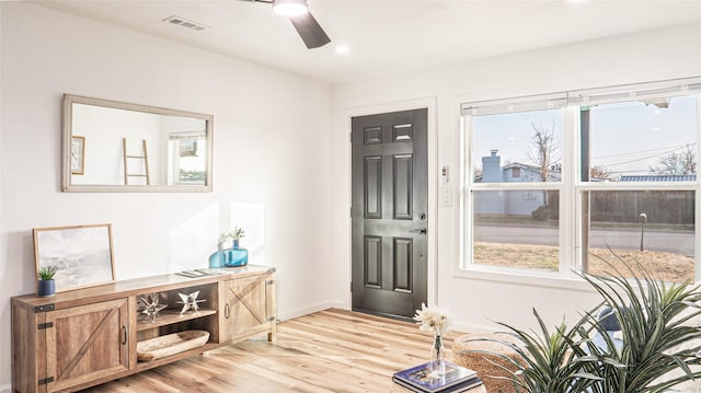 foyer featuring light hardwood / wood-style flooring, plenty of natural light, and ceiling fan