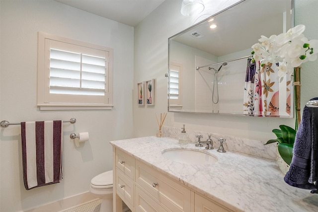 bathroom with vanity, curtained shower, and toilet