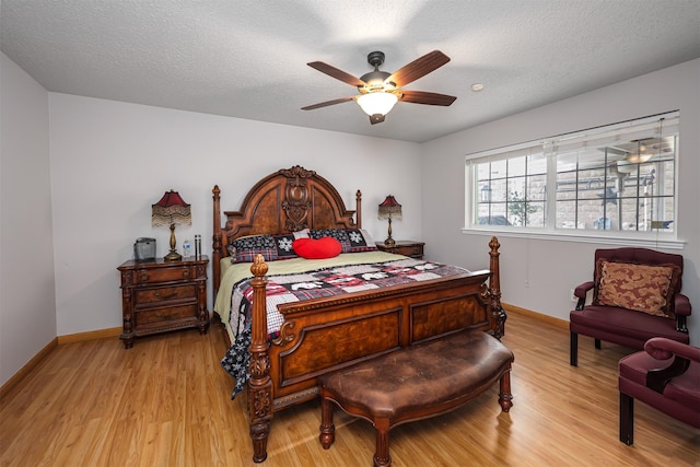 3029 Meadow Creek Ct, Grand Prairie, TX 75052 - bedroom featuring light wood finished floors, baseboards, a textured ceiling, and a ceiling fan