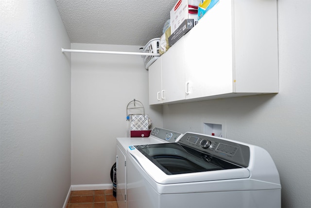 3029 Meadow Creek Ct, Grand Prairie, TX 75052 - clothes washing area featuring washing machine and dryer, cabinet space, baseboards, a textured ceiling, and tile patterned flooring