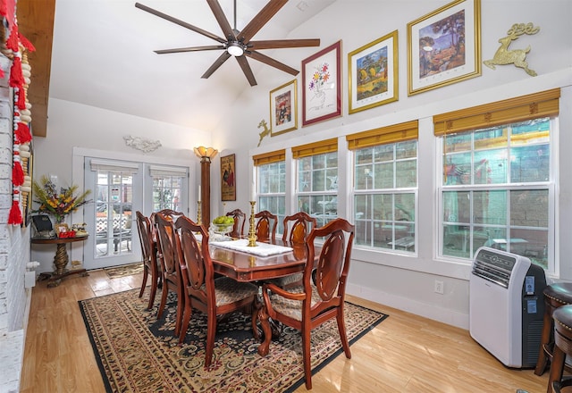 dining space with high vaulted ceiling, light hardwood / wood-style floors, french doors, and ceiling fan