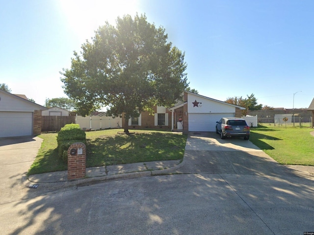 ranch-style house featuring a garage and a front lawn