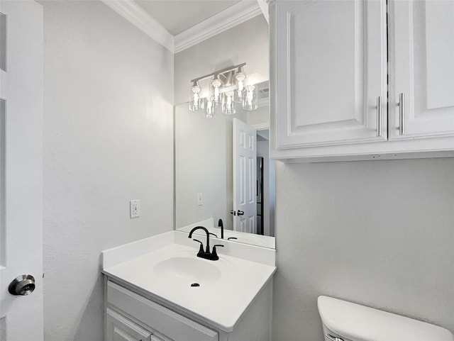 bathroom featuring crown molding, vanity, and toilet