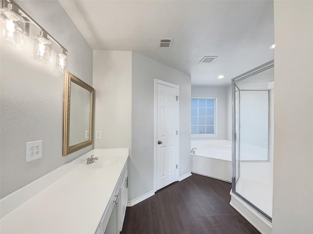 bathroom featuring hardwood / wood-style flooring, vanity, and independent shower and bath