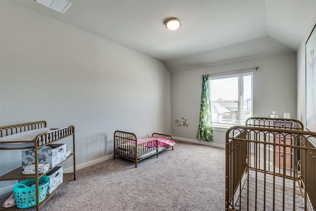 bedroom with lofted ceiling and carpet flooring