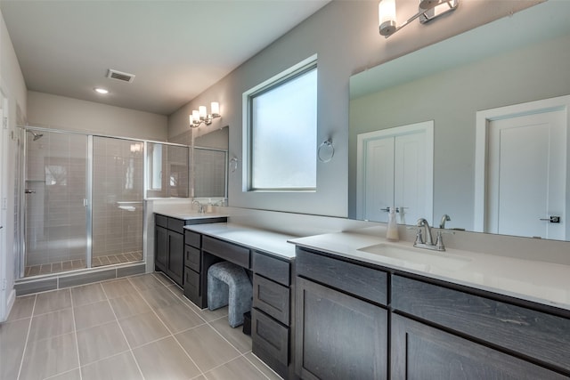 bathroom featuring an enclosed shower, vanity, and tile patterned floors