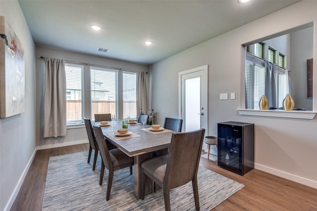 dining space featuring wine cooler and hardwood / wood-style flooring