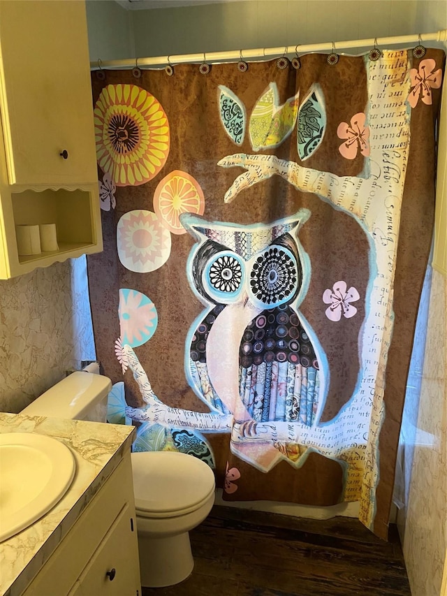 bathroom with vanity, toilet, and hardwood / wood-style floors