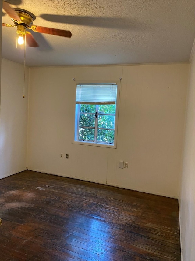 empty room with dark hardwood / wood-style flooring, ceiling fan, and a textured ceiling