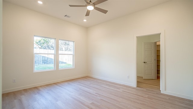 empty room with ceiling fan and light hardwood / wood-style floors