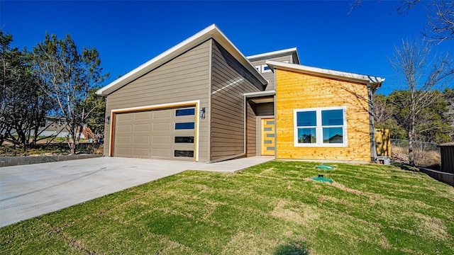 view of front of home with a garage and a front yard