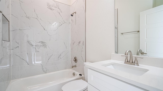 full bathroom with vanity, tiled shower / bath combo, and toilet