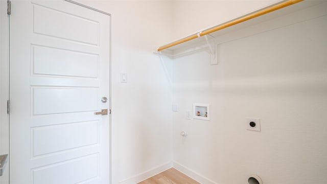 clothes washing area with hookup for a washing machine, electric dryer hookup, and light wood-type flooring