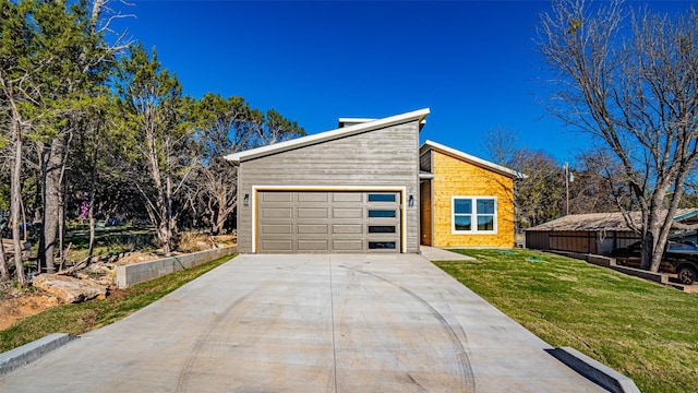 exterior space with a garage and a lawn