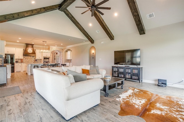 living room with beam ceiling, high vaulted ceiling, light hardwood / wood-style floors, and ceiling fan