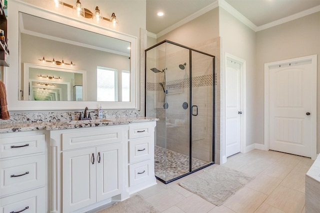 bathroom featuring vanity, crown molding, a shower with door, and tile patterned floors