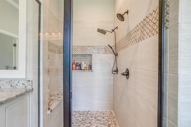 bathroom with vanity and a shower with shower door