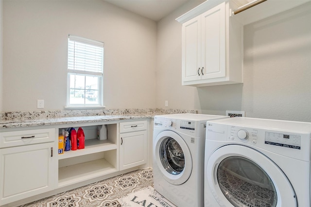 laundry room featuring light tile patterned floors, washer and clothes dryer, and cabinets