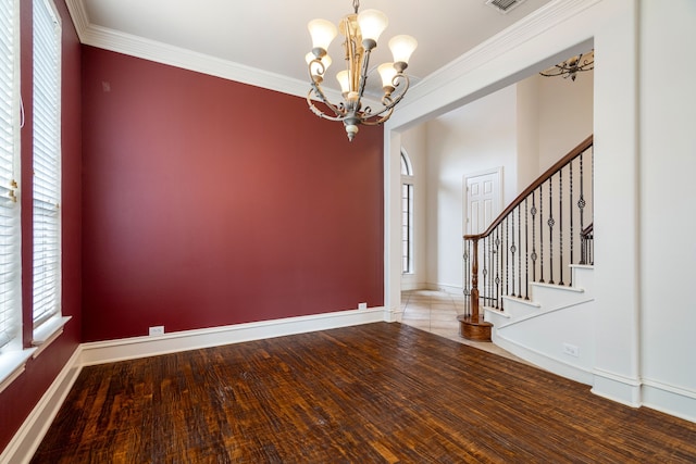 unfurnished room with a notable chandelier, wood-type flooring, and ornamental molding