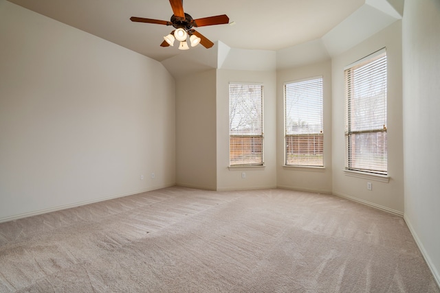 carpeted empty room with vaulted ceiling and ceiling fan