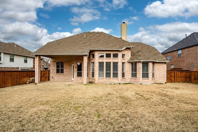 rear view of property featuring a yard and a patio area