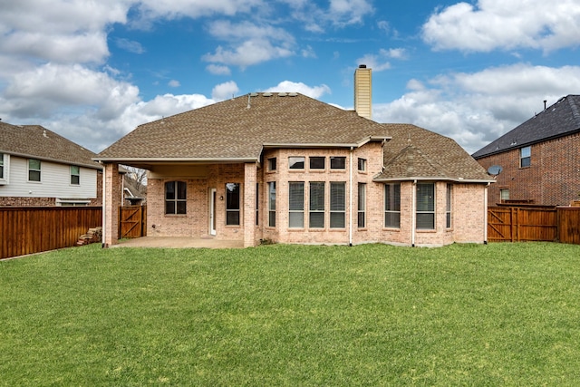 back of property with brick siding, a gate, a patio area, and a fenced backyard