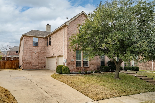 view of front of house with a garage and a front lawn