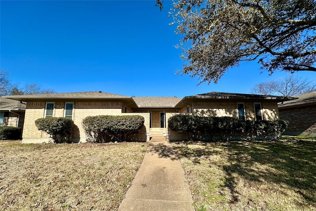 ranch-style home featuring a front yard