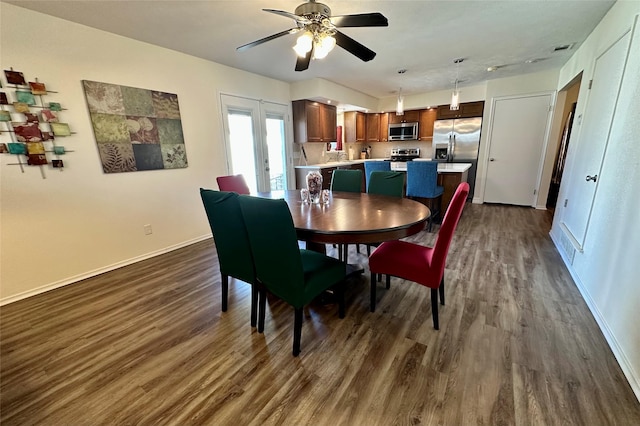 dining area featuring dark wood-type flooring and ceiling fan