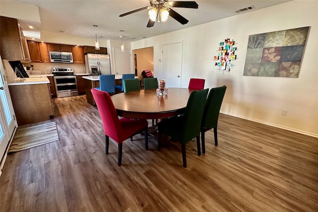 dining room featuring dark wood-type flooring and ceiling fan