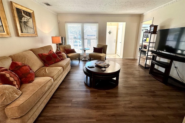 living room featuring ornamental molding, dark hardwood / wood-style floors, and a textured ceiling