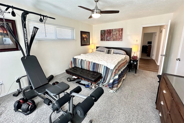 bedroom with ceiling fan, carpet floors, and a textured ceiling