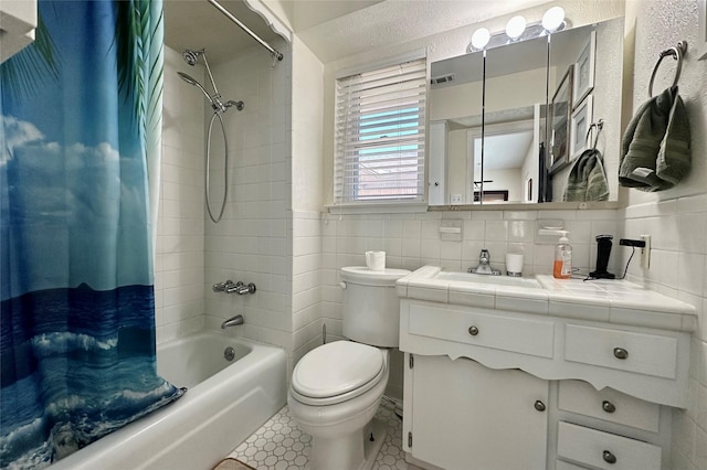 full bathroom with shower / bath combination with curtain, vanity, toilet, and tile walls