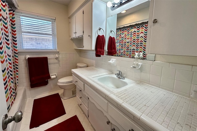 bathroom featuring tile walls, vanity, tile patterned floors, and toilet